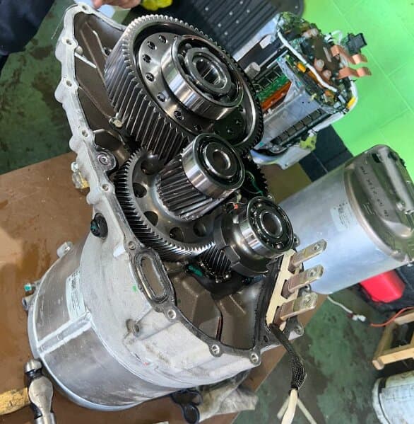An opened Tesla drive unit showing its gears and bearings