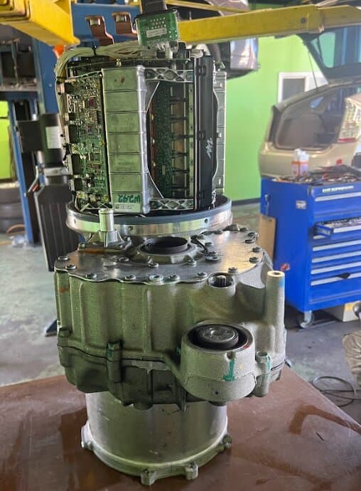 A Tesla drive unit standing upright with its inverter exposed
