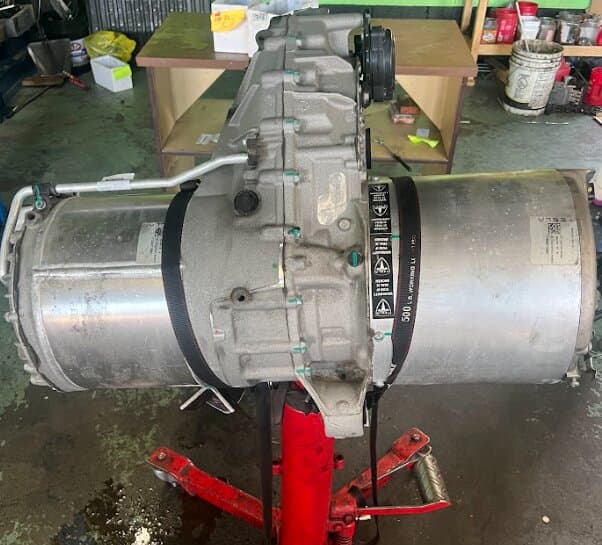 A Tesla drive unit supported on a transmission jack
