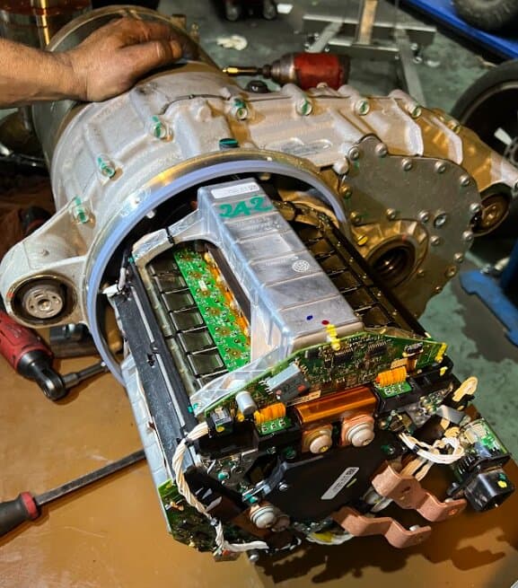 A Tesla drive unit opened on the bench for repair